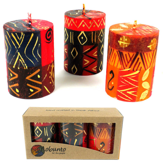 This set of three candles, hand-painted by South African artisans, arrives in a recycled cardboard gift box.  Each candle is 2.5 inches tall by 1.75 inches in diameter.